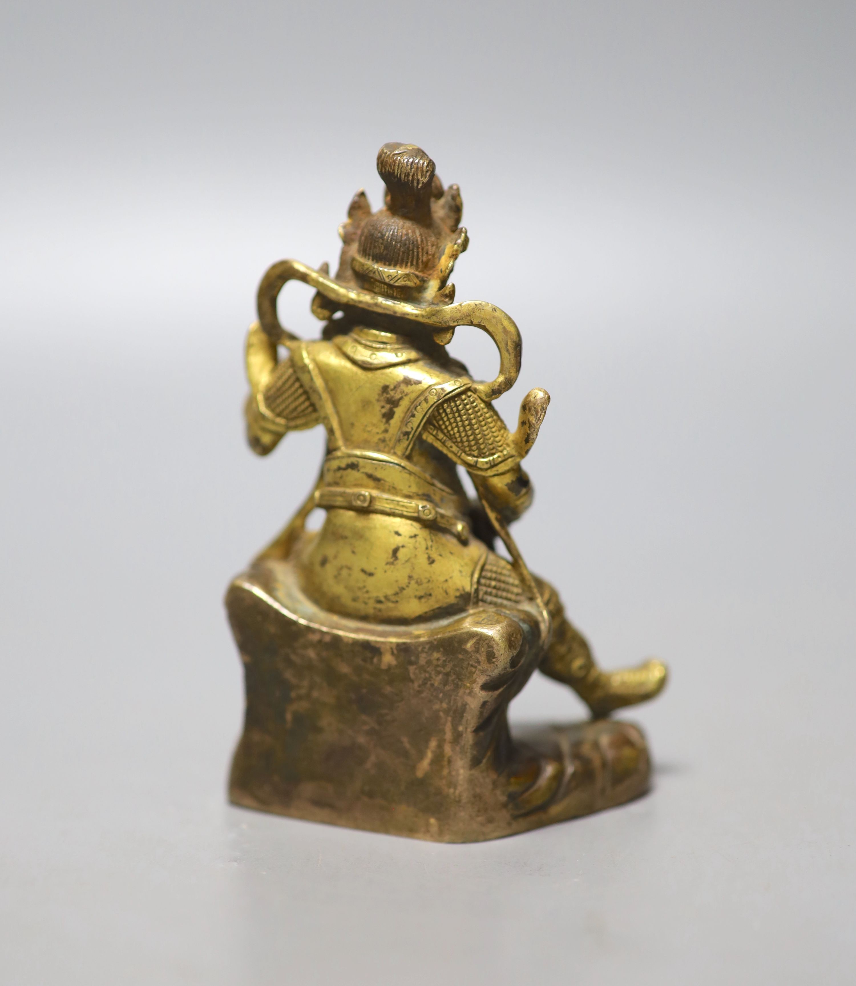 A Sino-Tibetan gilt bronze seated figure of Guandi, 10cm